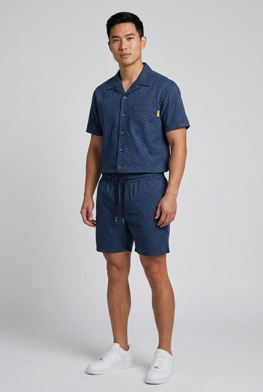Model wearing the Nijays Couture navy cross print shirt and matching shorts